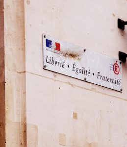 Close-up of the French motto 'Liberté, Égalité, Fraternité' on a wall in France.